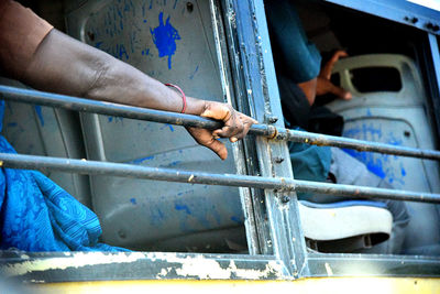Close-up of hand holding blue metal