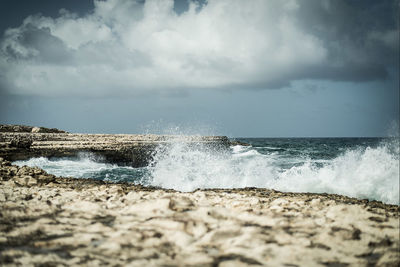 Scenic view of sea against cloudy sky