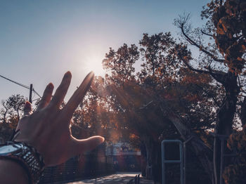 Midsection of person against sky during autumn