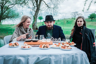 Young couple sitting on table