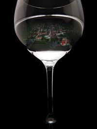 Close-up of wine glass against black background