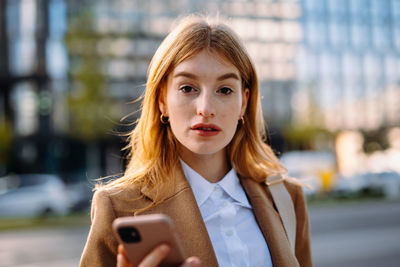 Portrait of young businesswoman using mobile phone