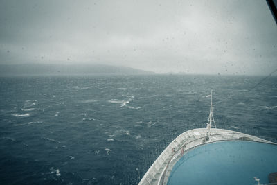 Boat sailing in sea against sky