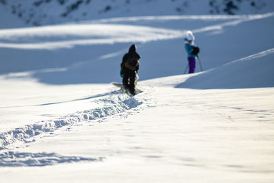 People walking on snow covered land