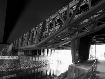 Low angle view of bridge over river against sky