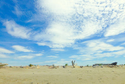 Scenic view of desert against cloudy sky