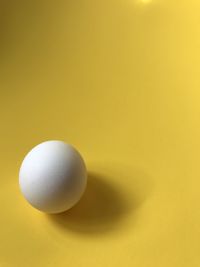 High angle view of ball on yellow background