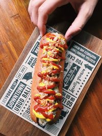 Close-up of human hand holding food on table