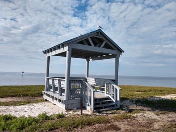 Lifeguard hut on beach against sky