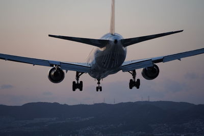 Low angle view of airplane flying against sky