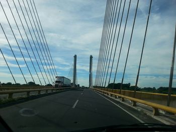 Low angle view of bridge against cloudy sky