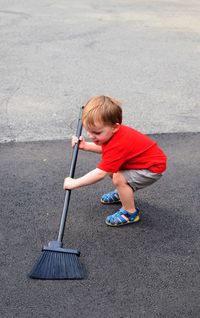High angle view of boy standing on road