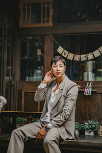 Portrait of young man sitting outdoors