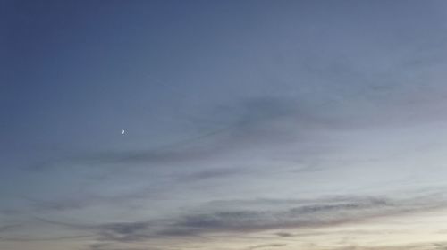 Low angle view of moon in sky at night