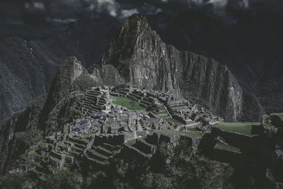 The ruins of machu picchu against mountains at night