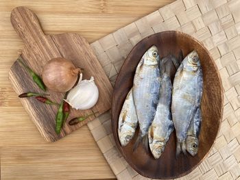 High angle view of fish on cutting board