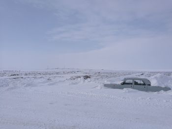 Scenic view of landscape against sky during winter