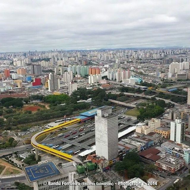 building exterior, architecture, built structure, city, cityscape, high angle view, sky, skyscraper, crowded, cloud - sky, residential district, tower, city life, residential building, cloudy, tall - high, road, tree, residential structure, office building