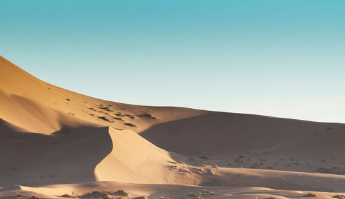 Scenic view of desert against clear sky