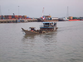 Nautical vessel on river against sky