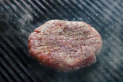 High angle view of meat on barbecue grill