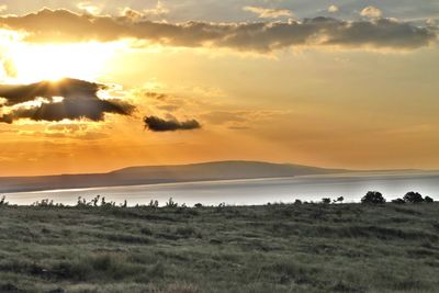 Scenic view of landscape against cloudy sky