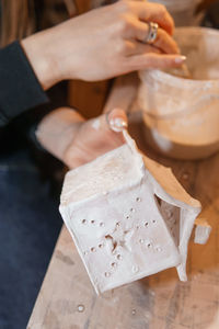 A master ceramist holds a clay product in his hands. making a ceramic candle holder from clay. 