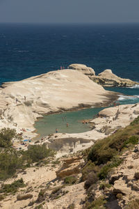 High angle view of rocks on beach against sky