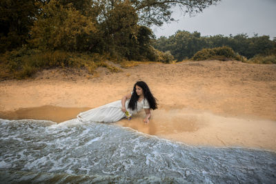 Full length portrait of woman in water