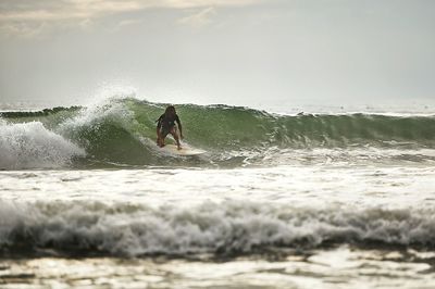 Woman jumping in sea