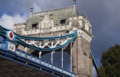 Low angle view of bridge and building against sky