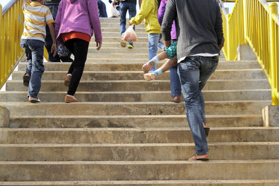 Low section of people walking on staircase
