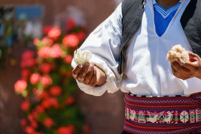 Midsection of man holding cotton