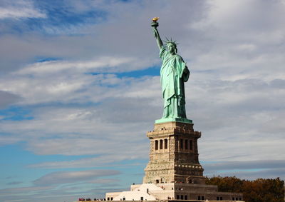 Statue of liberty against cloudy sky