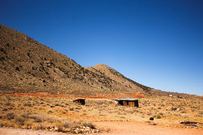 Built structure on arid landscape against clear blue sky