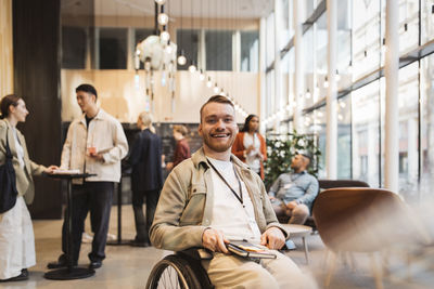 Portrait of happy male entrepreneur with disability during seminar at convention center