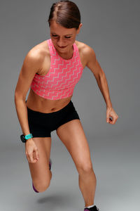 Portrait of young woman exercising against white background