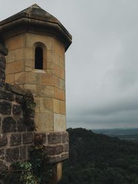 View of old building against cloudy sky