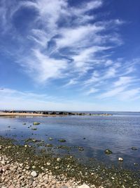 Calm bay shore with a stone pier against a very beautiful sky 