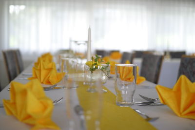 Close-up of yellow glass on table