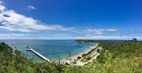 High angle view of bay against blue sky