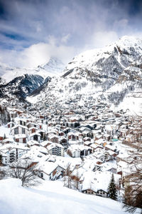 Aerial view of snow covered buildings in city