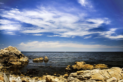 Scenic view of sea against cloudy sky