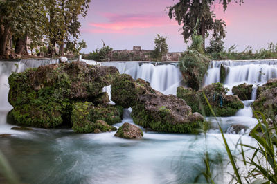 Scenic view of waterfall against sky