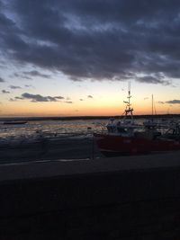 Scenic view of sea against cloudy sky during sunset