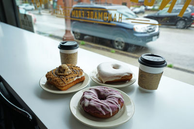 Close up assorted sweet donut served with hot coffee