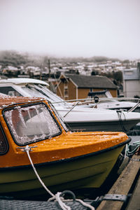 Aerial view of boat moored at harbor against sky