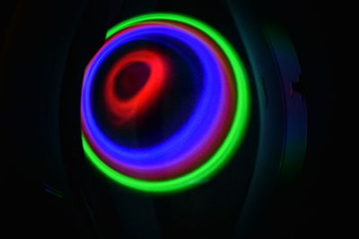 Close-up of multi colored light painting against black background