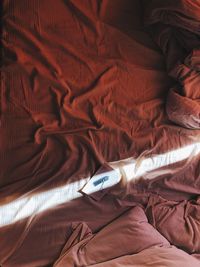 High angle view of man relaxing on bed at home