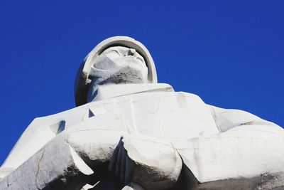 Low angle view of statue against blue sky